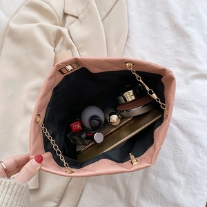 Bolso saco rosa acolchado con cadena muestra espacio para teléfono y cosméticos