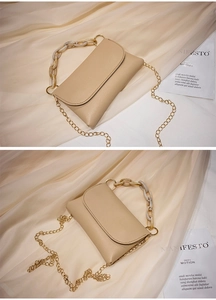 Détail du sac carré beige avec chaîne ambrée marbrée et bandoulière dorée