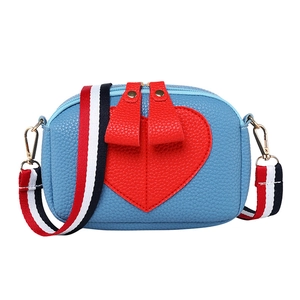 Women's blue pebble leather crossbody bag with red heart patch and striped shoulder strap