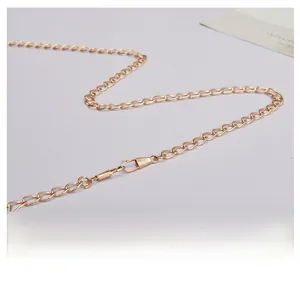 Detail of light gold flat link metal chain strap with lobster clasp for small square bags