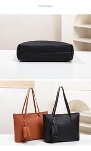 Close-up of woven texture and dual handles on black and tan large tote bags