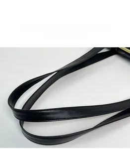 Detail of soft black leather handle with reinforced stitching on a minimalist tote bag