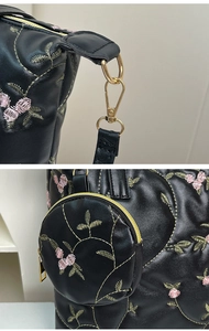 Detail of floral embroidery on black PU leather bag with detachable round coin purse