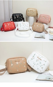 Detailed embroidery on vibrant square crossbody bags with wide adjustable straps
