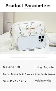 Detail of white PU crossbody bag with floral embroidery and smartphone for size comparison
