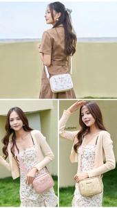 Close-up of floral embroidery and metal logo on a stylish crossbody camera bag