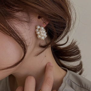 Elegant French vintage cluster pearl earrings with gold beads shown on model ear