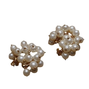 Elegant gold-tone cluster stud earrings featuring lustrous white pearls in a bold style