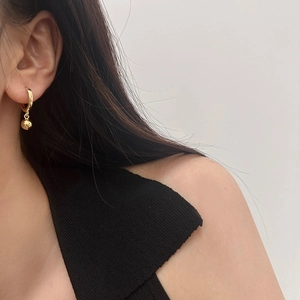 Minimalist gold hoop earrings with sphere drop pendant on model for daily wear