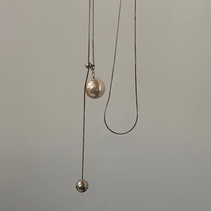 Adjustable silver snake chain necklace featuring a champagne pearl pendant and sliding toggle