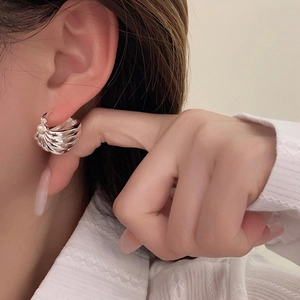 Vintage silver striped shell earrings with pearls shown worn on a model's ear