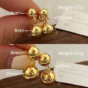 Detail showing two sizes of 18K gold polished double sphere earrings with measurements