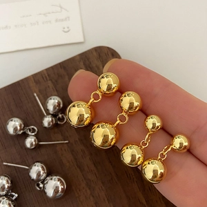 Minimalist double silver and gold ball earrings with high polish mirror finish surface