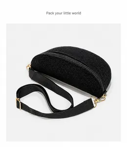 Detail of black corduroy crescent bag showing fabric texture and gold metal hardware