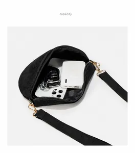 Detail view of the black corduroy bag interior showing space for phone and power bank