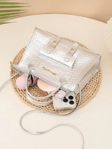 Detail view of silver crocodile pattern handbag showing interior capacity for essentials