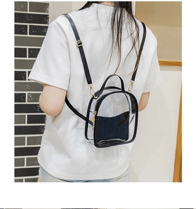 Detailed back view of a mini transparent PVC backpack with black faux leather trim and straps