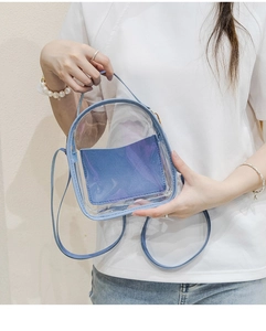 Detail of transparent PVC mini backpack with blue leather trim and matching inner pouch
