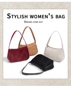 Detail of four colorful suede baguette bags with zip closures and smooth leather handles