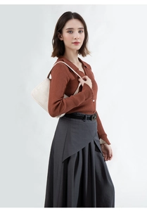 Chic cream leather underarm bag styled with a caramel polo knit top and pleated grey skirt