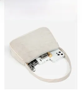 Interior view of the cream shoulder bag showing storage capacity for daily essentials