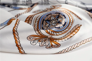 Detail of nautical satin scarf showing orange rope and blue star compass patterns