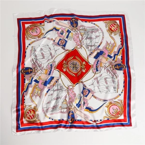 Flat lay of 90cm nautical silk scarf featuring vintage sailboats and anchor patterns