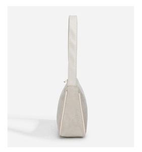 Detailed side view of beige shoulder bag showing leather strap and textured fabric finish
