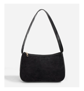 Front view of black baguette bag in matte suede with smooth leather strap and gold zipper