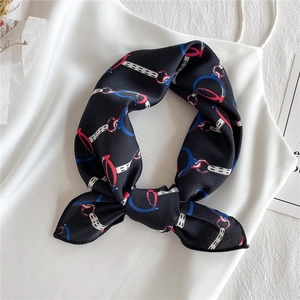 Elegant satin scarf with vintage chain and horsebit print over a white camisole top