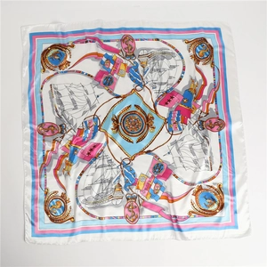 Macro detail of nautical silk scarf featuring vintage ship anchor print and satin luster