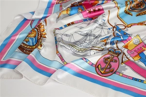 Close-up of nautical satin scarf featuring detailed sailboat prints and silky fabric texture