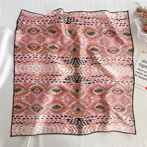 Detail of pink and orange snake pattern silk scarf with premium stitched edges