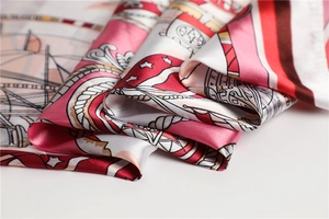 Detail of nautical print silk scarf featuring anchors and vintage patterns with satin luster