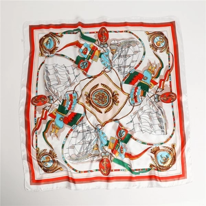 Detail of vintage nautical silk scarf with sailboat and anchor motifs on satin fabric