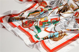 Detail of nautical print silk scarf featuring golden anchors and sailing ships on satin