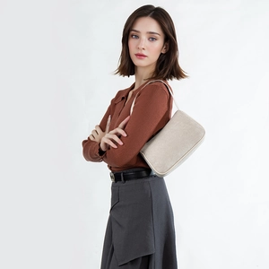 Minimalist beige fabric small square shoulder bag for women shown on a model