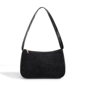 Minimalist black suede baguette shoulder bag with gold zipper on a clean white background