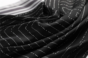 Macro shot of striped satin fabric texture with geometric dotted lines and smooth draping