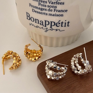 Minimalist C-shaped silver and gold tiered bead earrings in a stylish geometric design