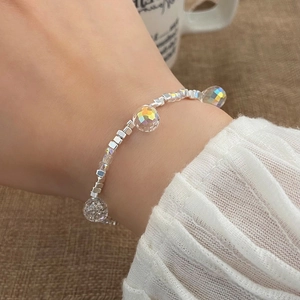 Elegant beaded bracelet with silver blocks and iridescent AB crystals on wrist