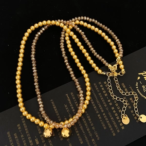 Double-layered gold pearl and champagne crystal necklace set with metal round pendant