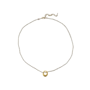 Minimalist silver bead chain necklace with a unique golden irregular lava ring pendant