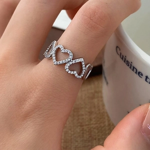 Elegant silver open ring with hollow heart patterns and cubic zirconia micro-pave