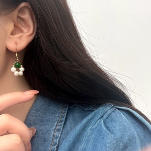 Elegant freshwater pearl drop earrings with green bead flower design on golden hook