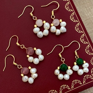 Fashion freshwater pearl drop earrings with colored gemstones on vintage red jewelry box