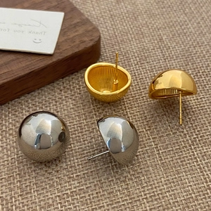 Minimalist shiny ball dome earrings in gold and silver finish on rustic background
