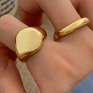 Polished gold signet ring and minimalist band set for men and women in a modern style