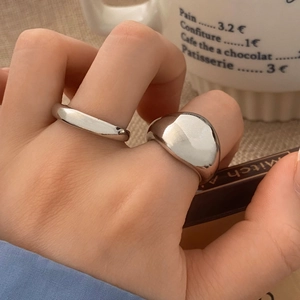 Set of two minimalist polished silver rings featuring a wide dome and thin wave design