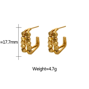 Detailed view of gold plated C-shape hoop earrings with double row geometric bead patterns